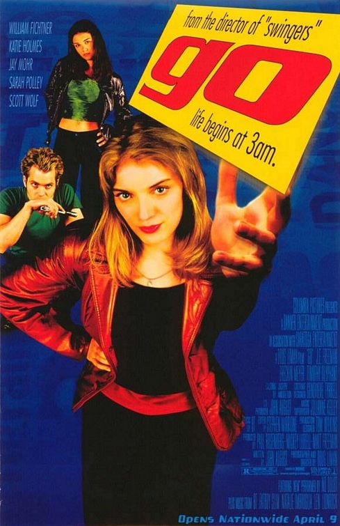 The poster for 1999 comedy/thriller Go. A young woman throws a business card, on which is written the film's title and tagline: "Life begins at 3 A.M." In the background are two supporting characters, a man crouching with his hands over his face and a woman standing apprehensively.