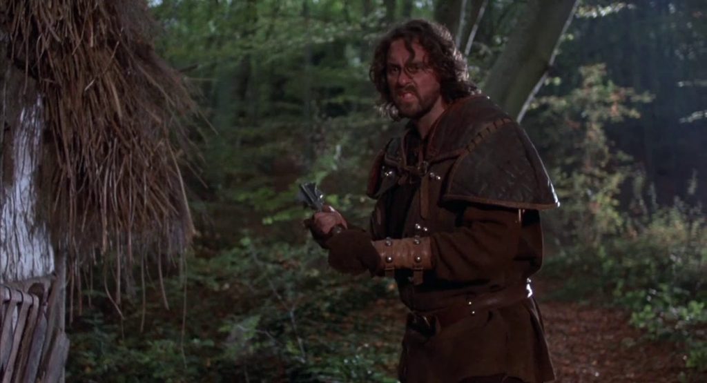 A medieval guy holds a mace menacingly.