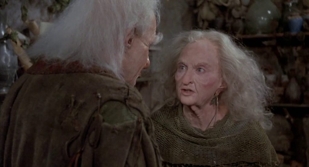 Two old people in ragged robes have an argument.