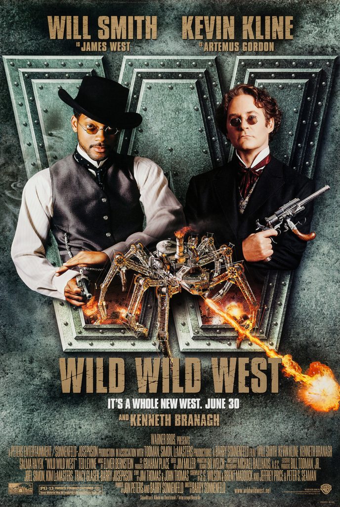 Will Smith and Kevin Kine pose awkwardly on either side of a giant mechanical spider. The spider shoots out a jet of flame that looks phallic.